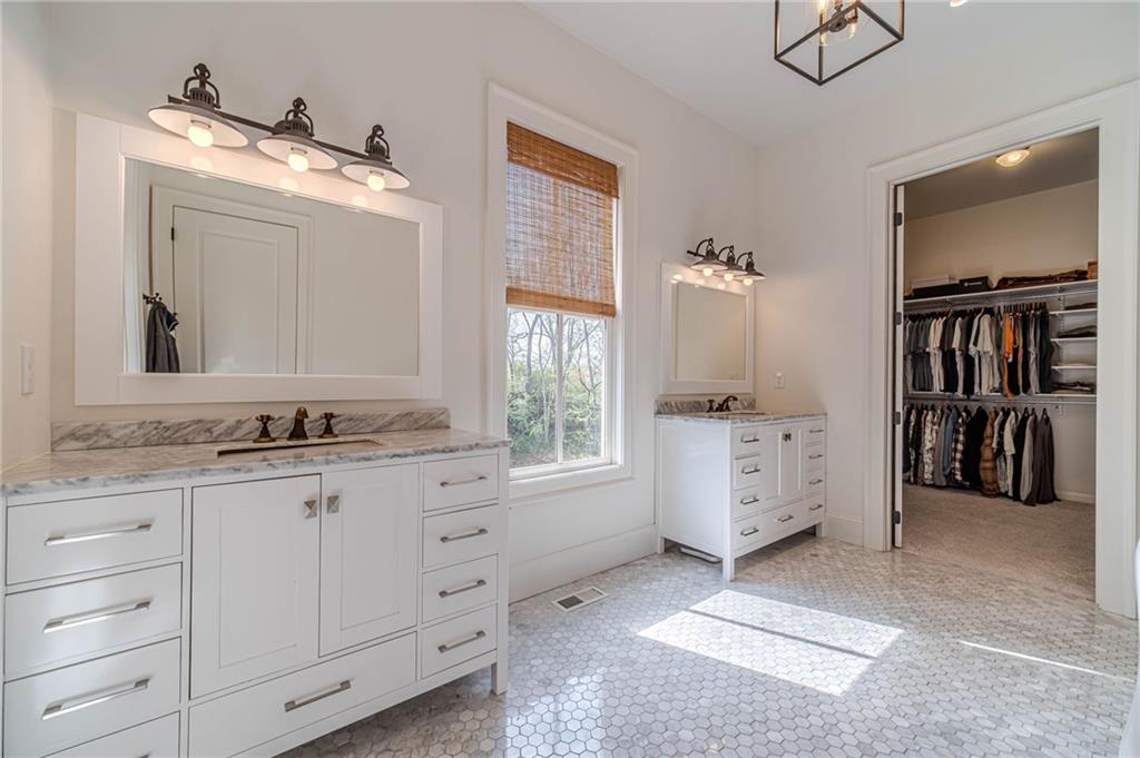 220 Audreys Way Suwanee, GA 30024 - Photo 30 of 66 a spacious bathroom with a granite countertop sink and a mirror