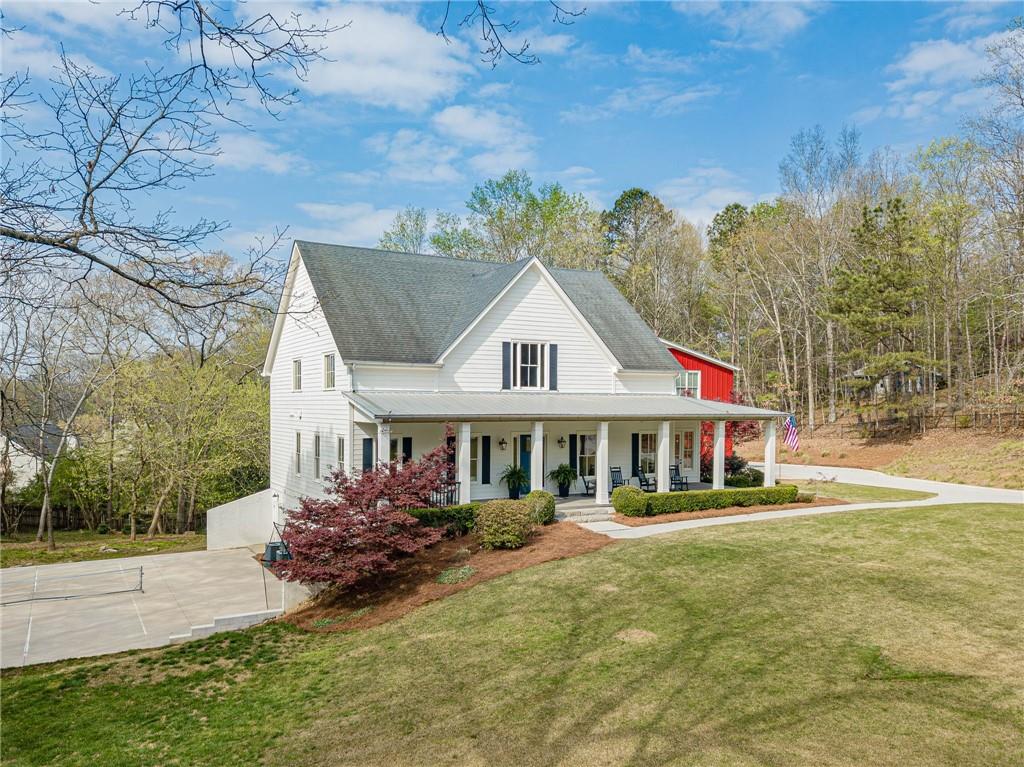 220 Audreys Way Suwanee, GA 30024 - Photo 3 of 66 a front view of a house with a yard table and chairs