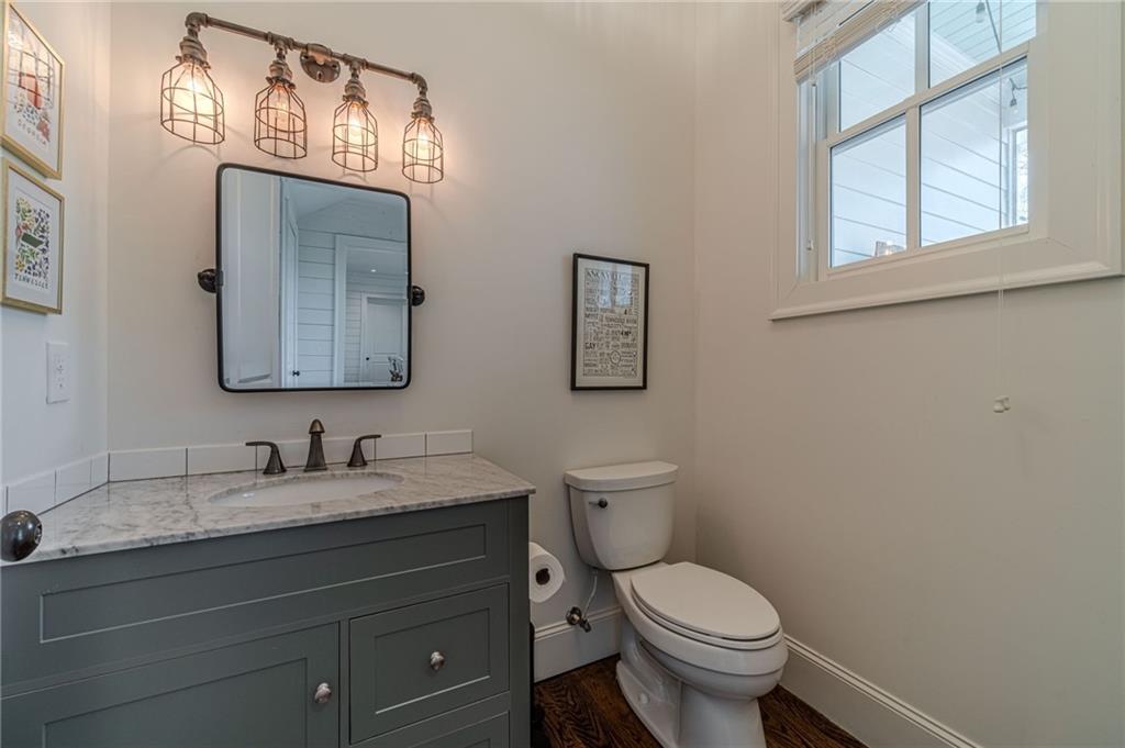 220 Audreys Way Suwanee, GA 30024 - Photo 35 of 66 a bathroom with a toilet sink and mirror