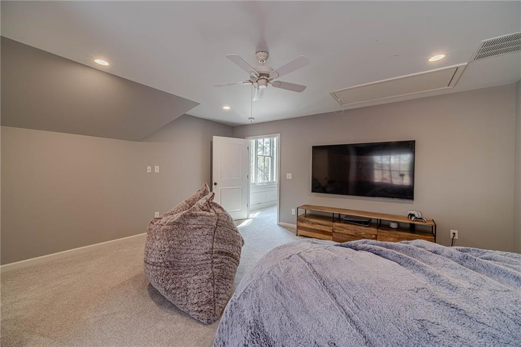 220 Audreys Way Suwanee, GA 30024 - Photo 38 of 66 a bedroom with furniture and a flat screen tv
