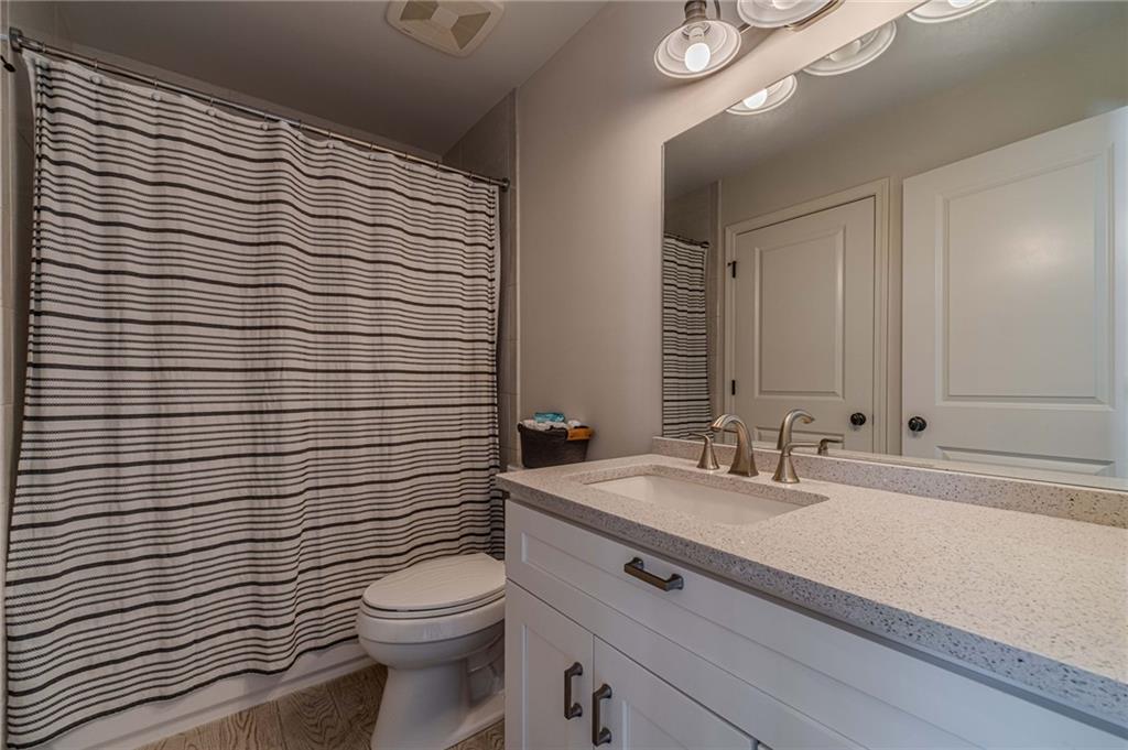 220 Audreys Way Suwanee, GA 30024 - Photo 40 of 66 a bathroom with a sink a toilet and mirror