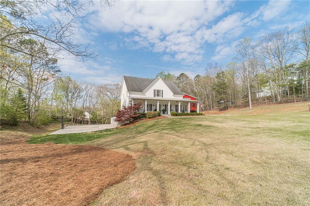220 Audreys Way Suwanee, GA 30024 - Photo 4 of 66 a view of a house with a yard and large trees