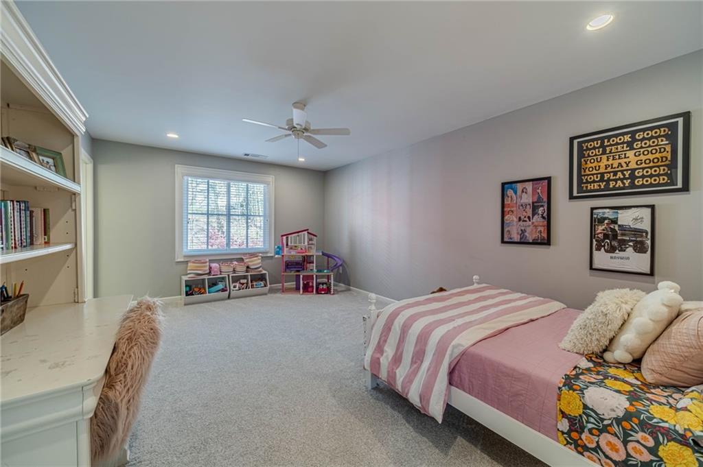 220 Audreys Way Suwanee, GA 30024 - Photo 43 of 66 a bedroom with a bed furniture and a window