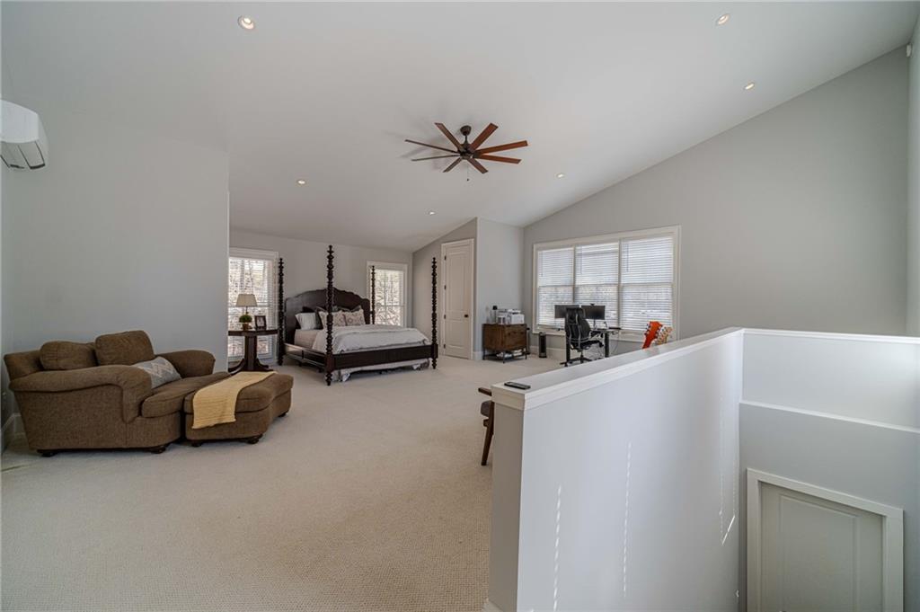 220 Audreys Way Suwanee, GA 30024 - Photo 51 of 66 a living room with furniture and a chandelier