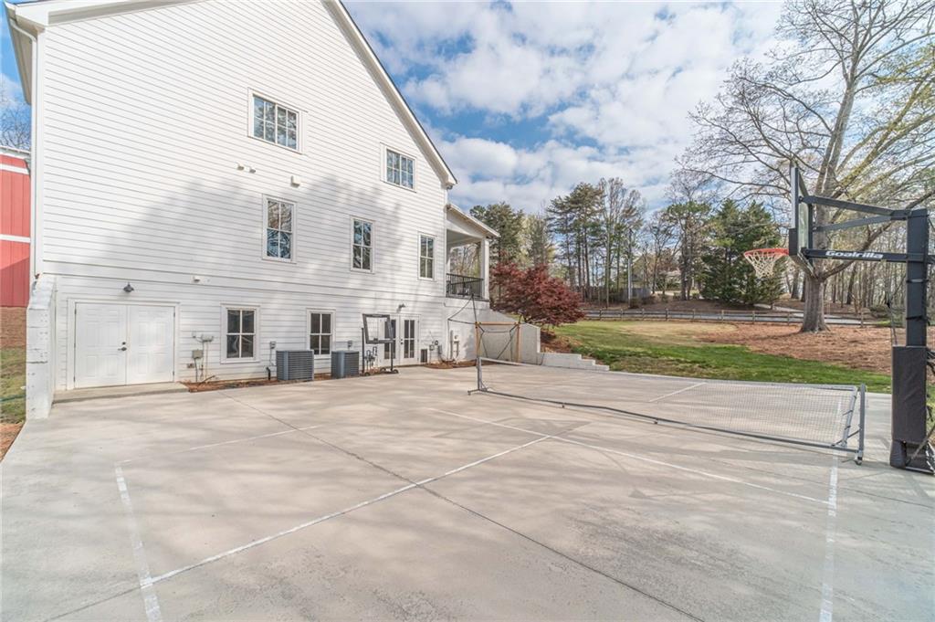 220 Audreys Way Suwanee, GA 30024 - Photo 59 of 66 a view of a white house with a yard and pathway