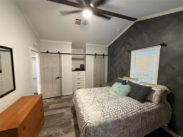 a bedroom with a bed and a walk in closet