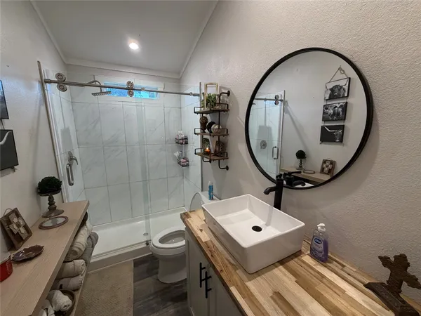 a bathroom with a sink a toilet and a mirror