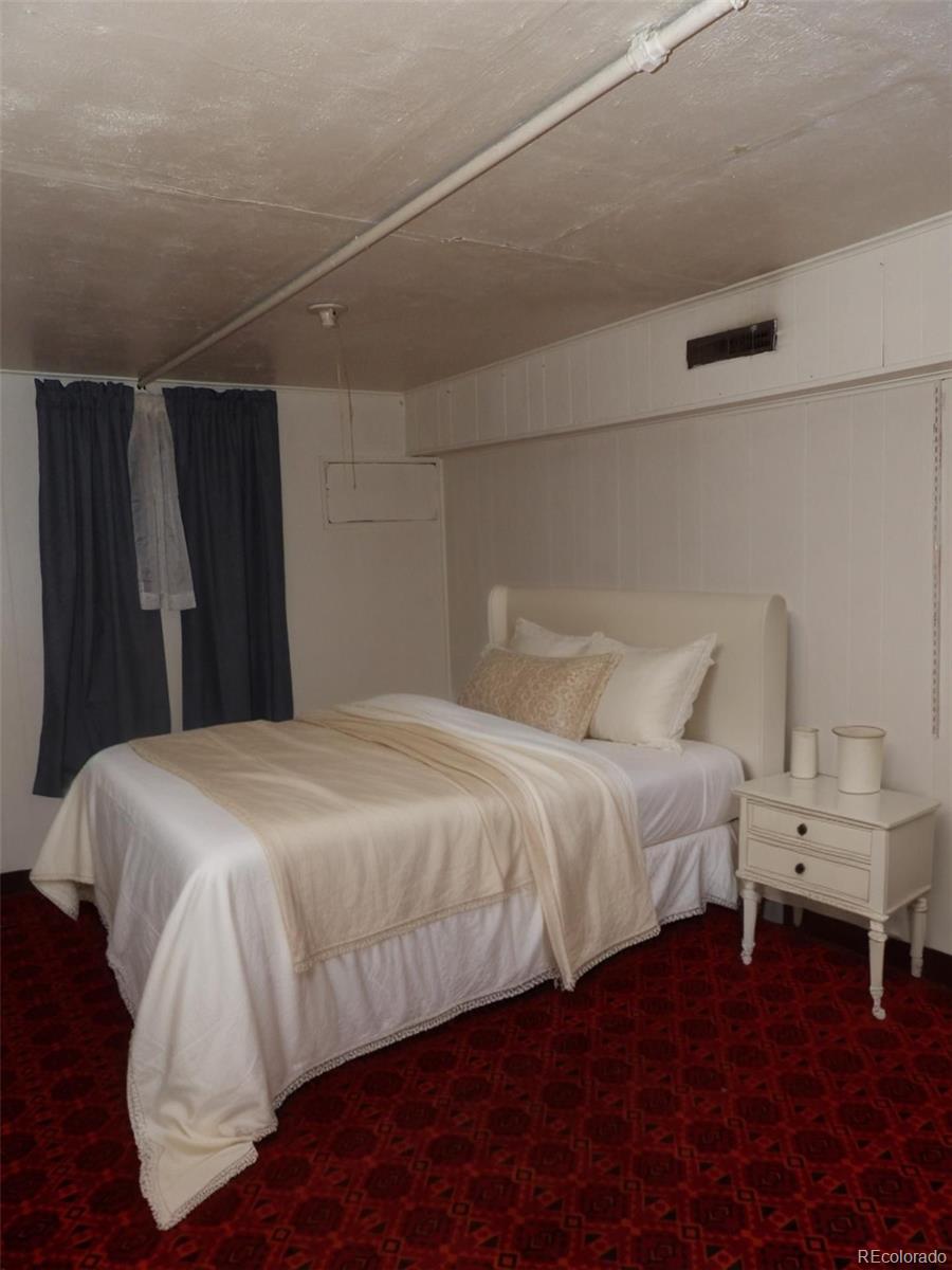 910 Elm Street Pueblo, CO 81004 - Photo 11 of 17 a bedroom with a bed and a walk in closet