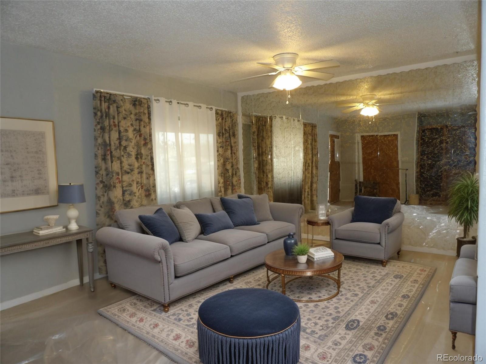910 Elm Street Pueblo, CO 81004 - Photo 2 of 17 a living room with furniture and a chandelier