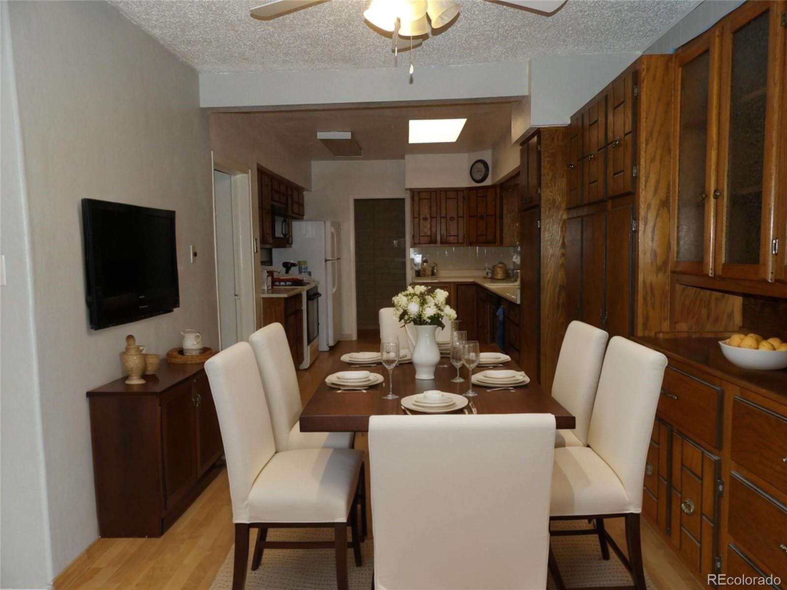 910 Elm Street Pueblo, CO 81004 - Photo 3 of 17 a dining room with furniture a flat screen tv and a chandelier