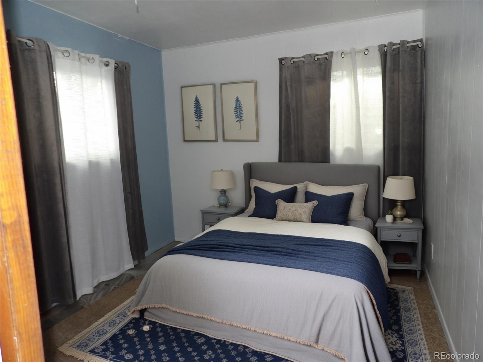 910 Elm Street Pueblo, CO 81004 - Photo 4 of 17 a bedroom with a bed and a window