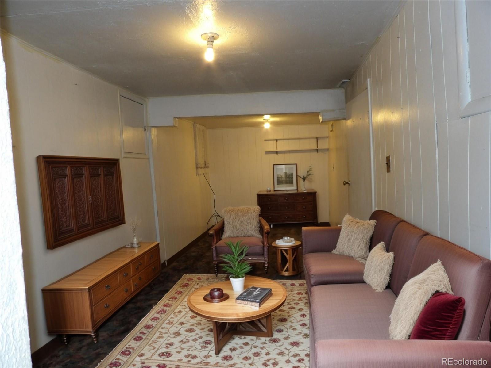 910 Elm Street Pueblo, CO 81004 - Photo 9 of 17 a living room with furniture and a wooden floor