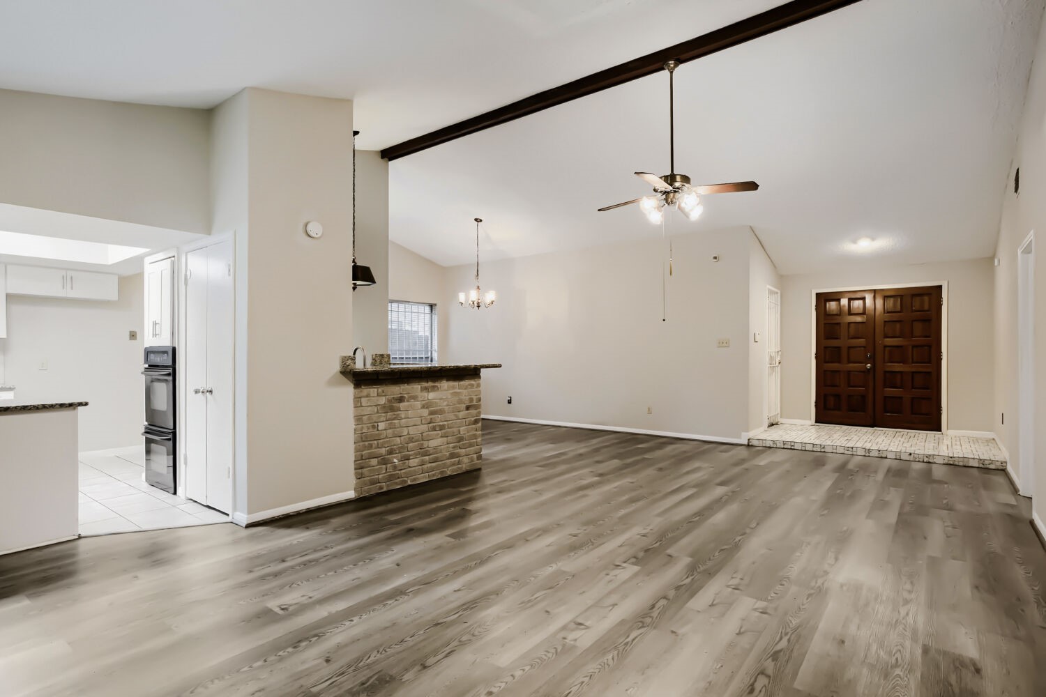 10103 Inwood Shadows Street Houston, TX 77088 - Photo 4 of 32 an empty room with wooden floor and ceiling fan