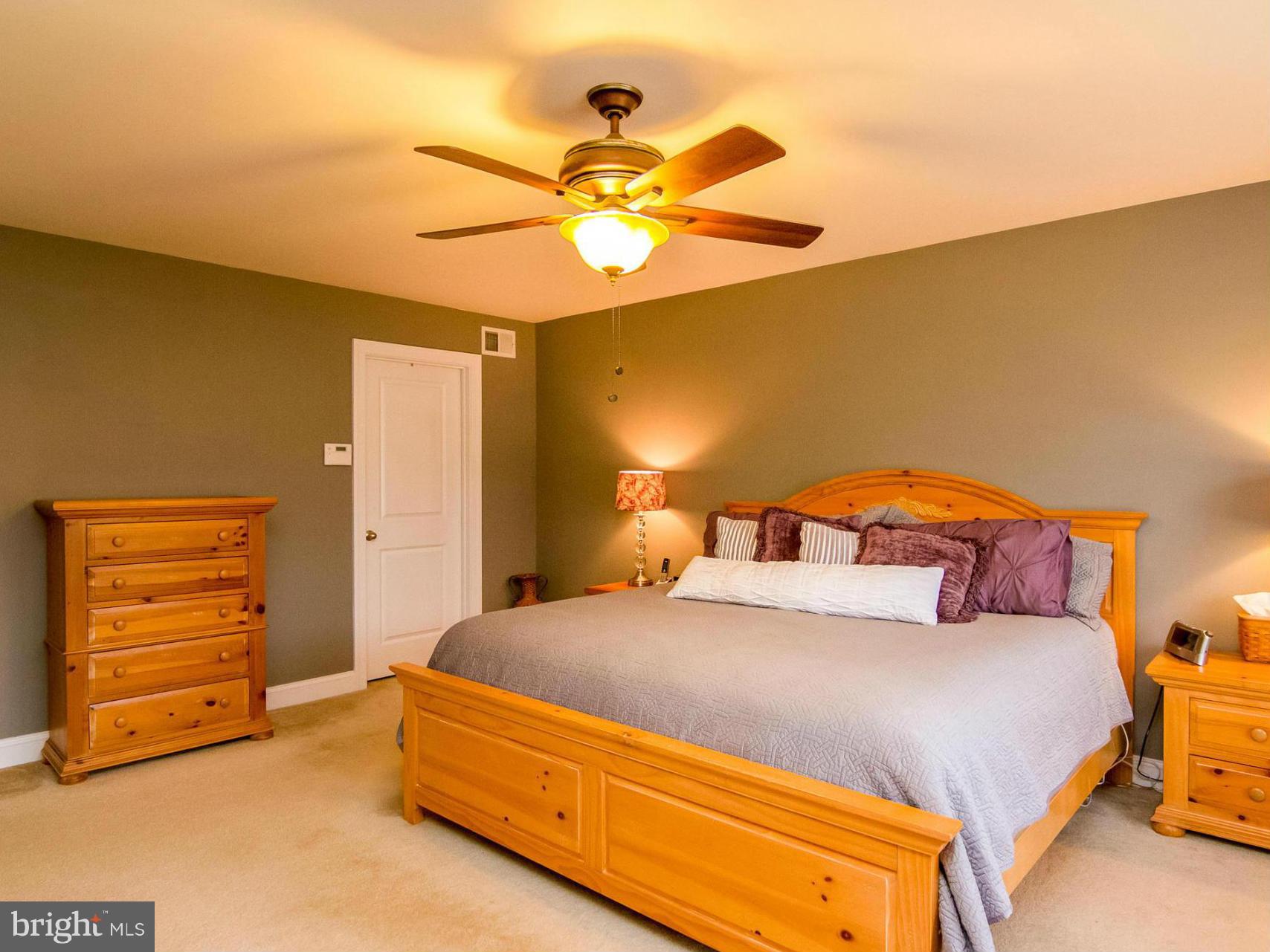 4021 Brummel Road Pasadena, MD 21122 - Photo 15 of 27 a bedroom with a bed and a chandelier