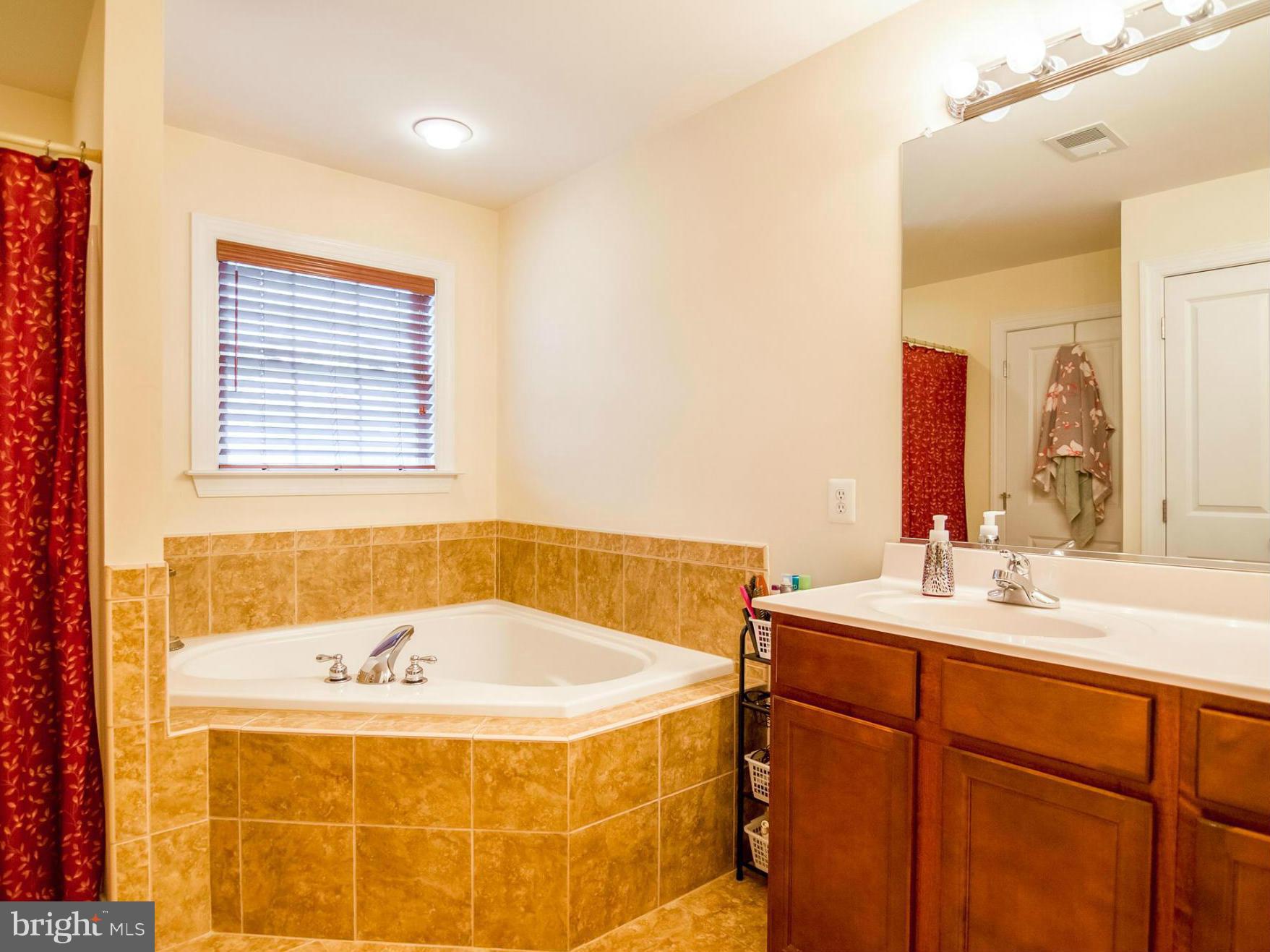 4021 Brummel Road Pasadena, MD 21122 - Photo 16 of 27 a bathroom with a tub sink and a mirror