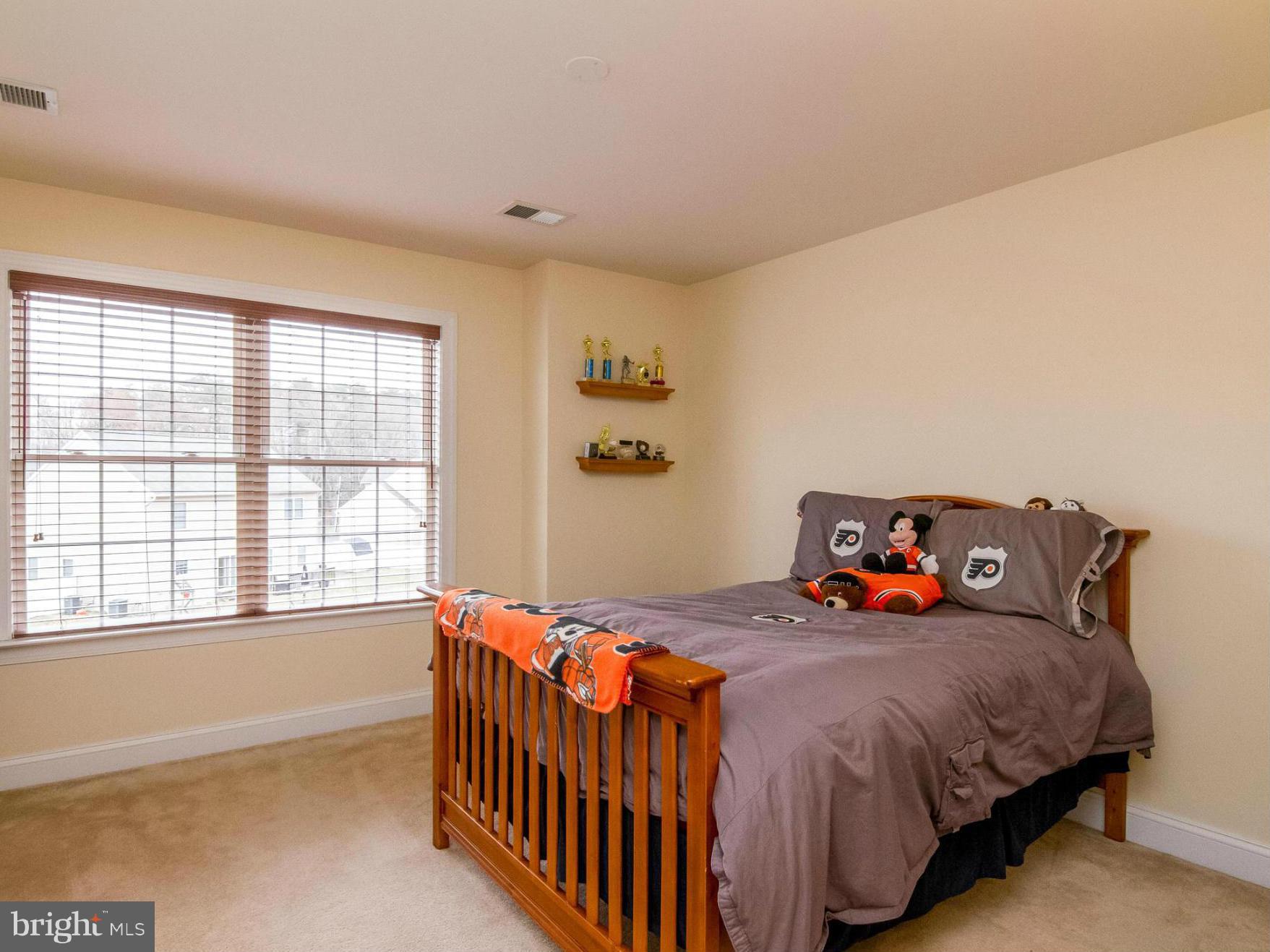 4021 Brummel Road Pasadena, MD 21122 - Photo 19 of 27 a bedroom with a bed and a large window