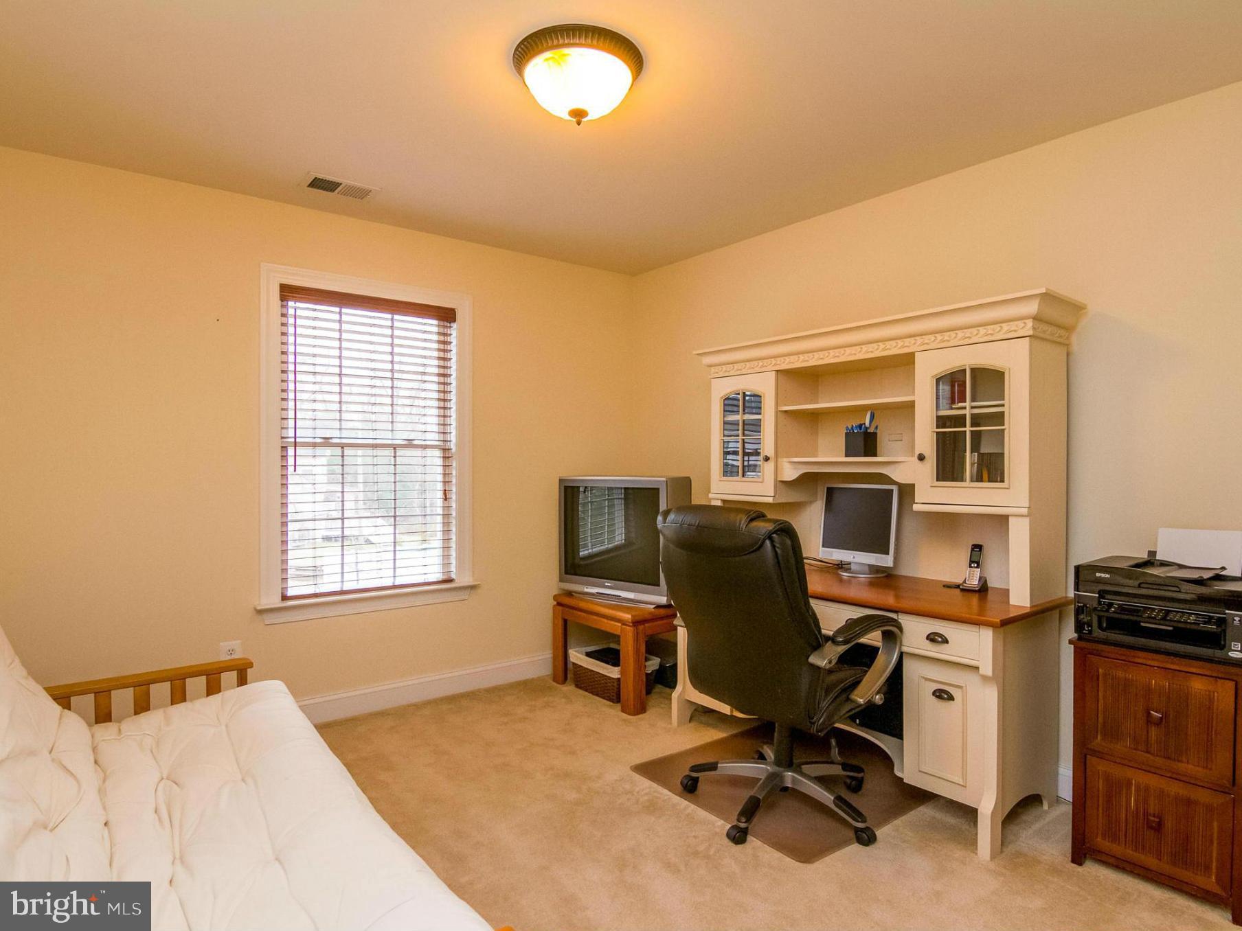 4021 Brummel Road Pasadena, MD 21122 - Photo 22 of 27 a view of a workspace with furniture and a window