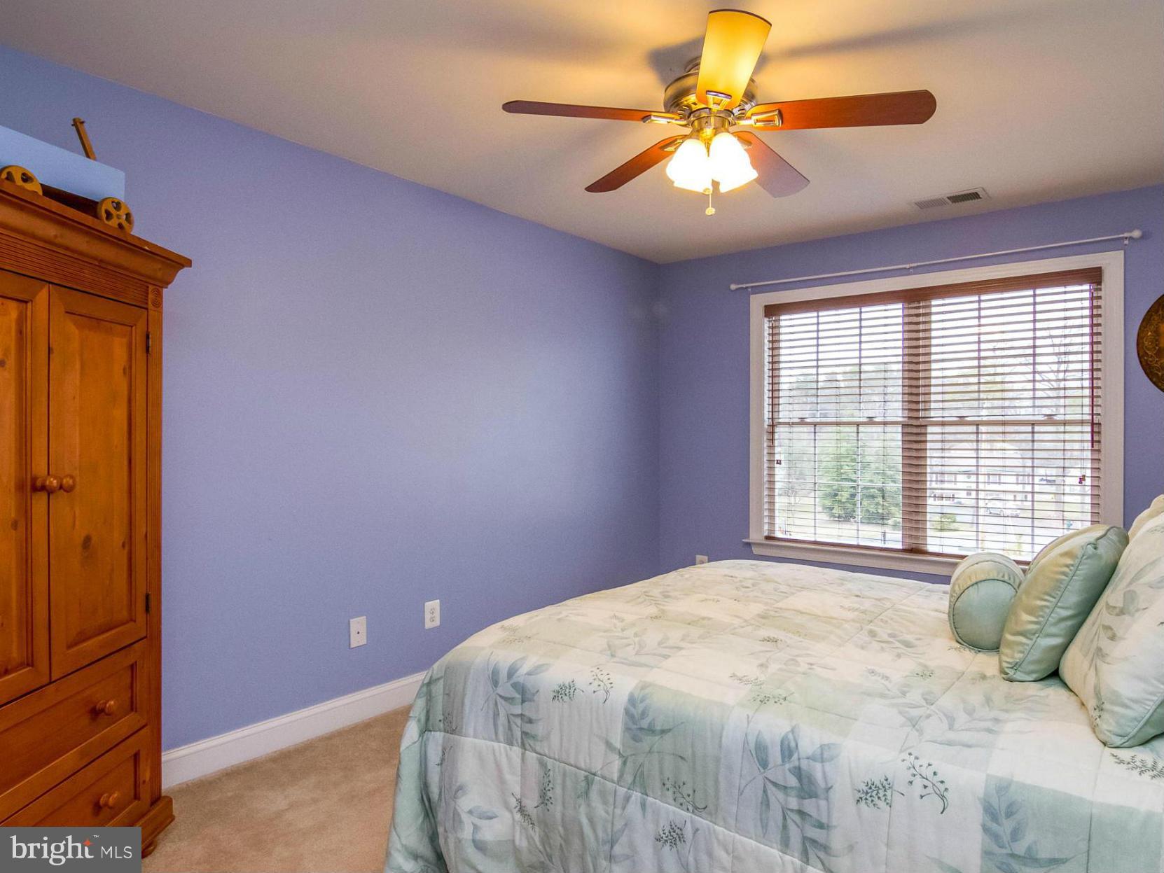 4021 Brummel Road Pasadena, MD 21122 - Photo 24 of 27 a bedroom with a bed and a chandelier