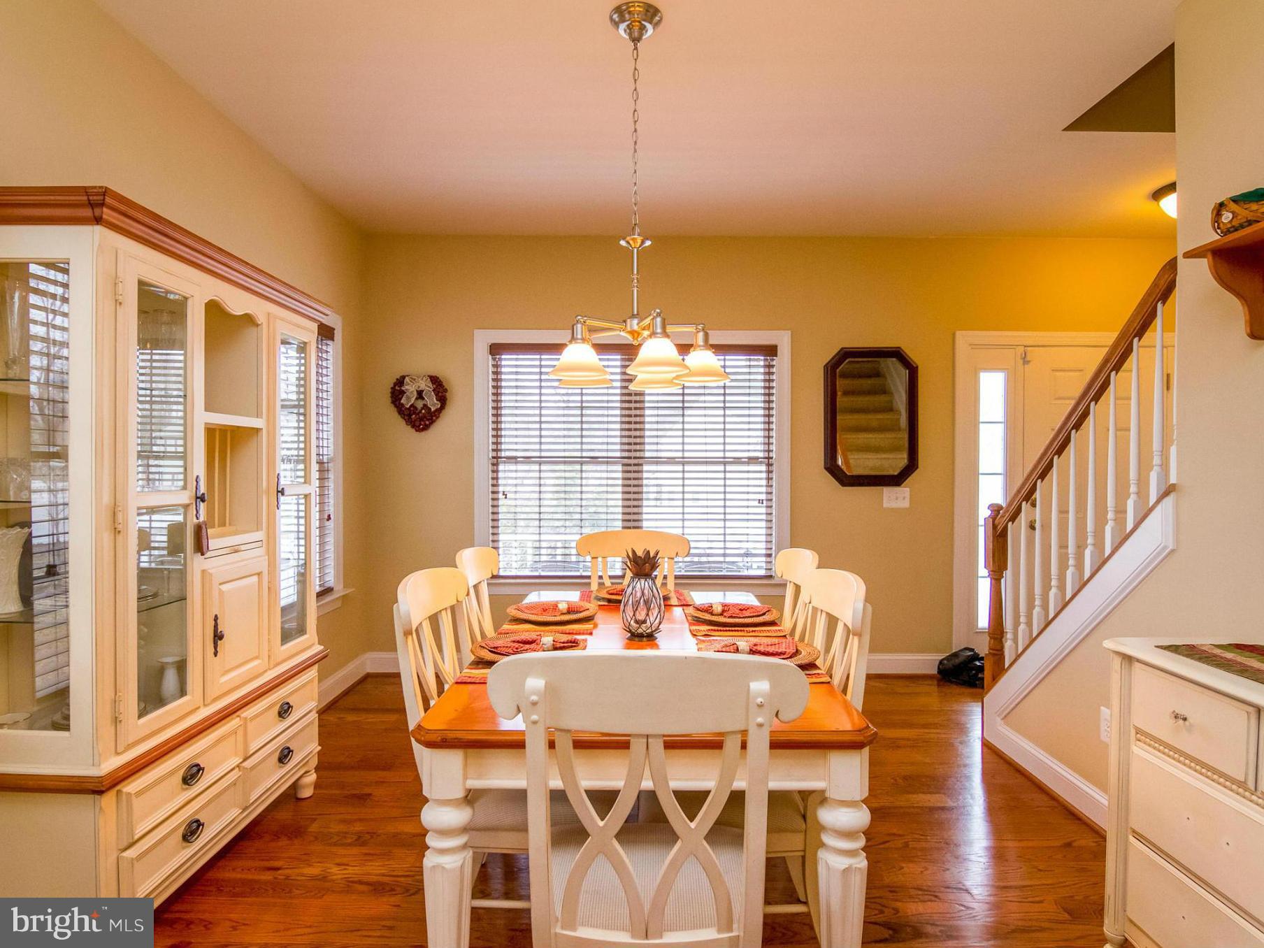 4021 Brummel Road Pasadena, MD 21122 - Photo 7 of 27 a view of a dining room with furniture a chandelier and wooden floor