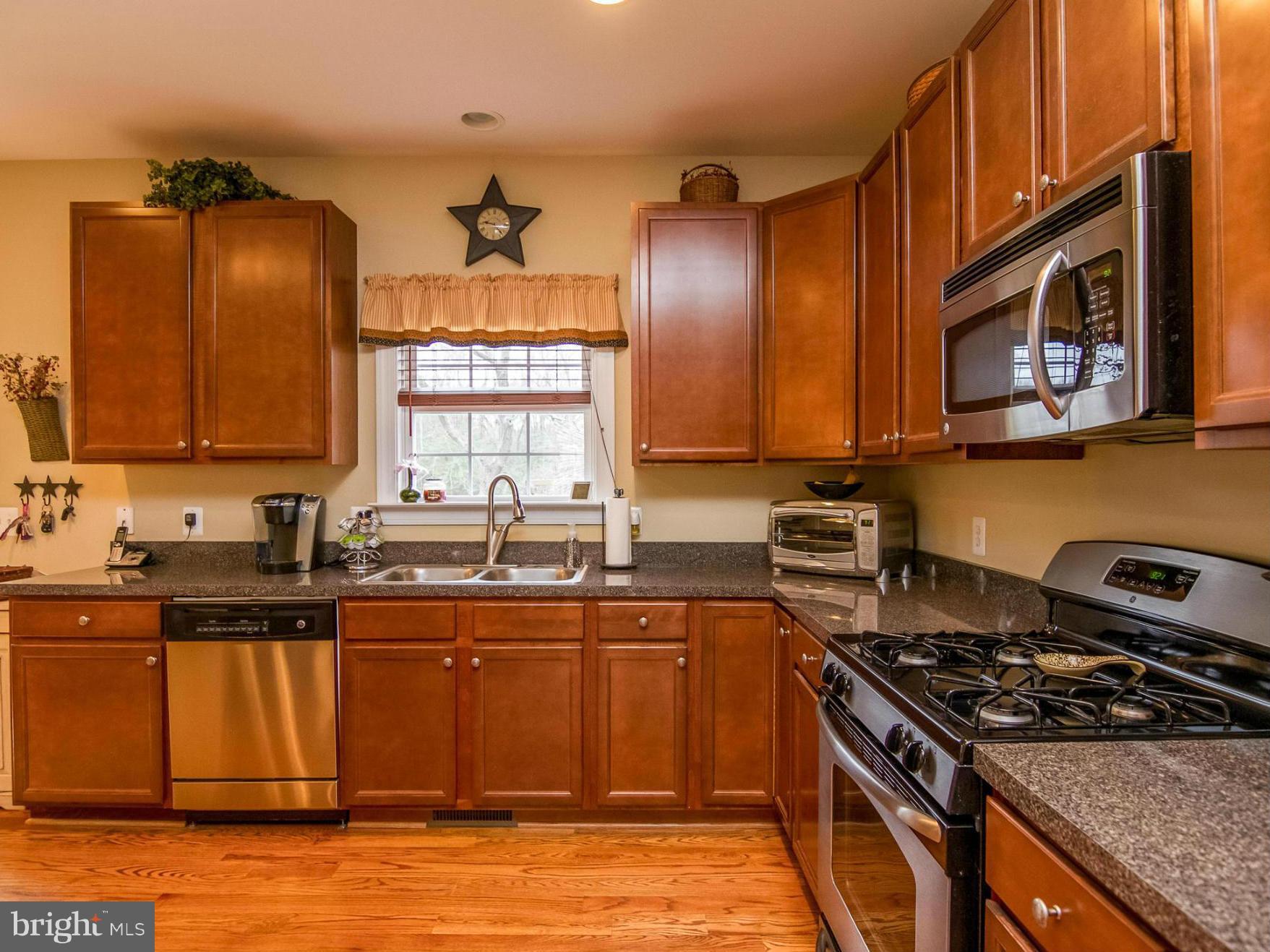 4021 Brummel Road Pasadena, MD 21122 - Photo 9 of 27 a kitchen with stainless steel appliances granite countertop a stove a sink and a microwave