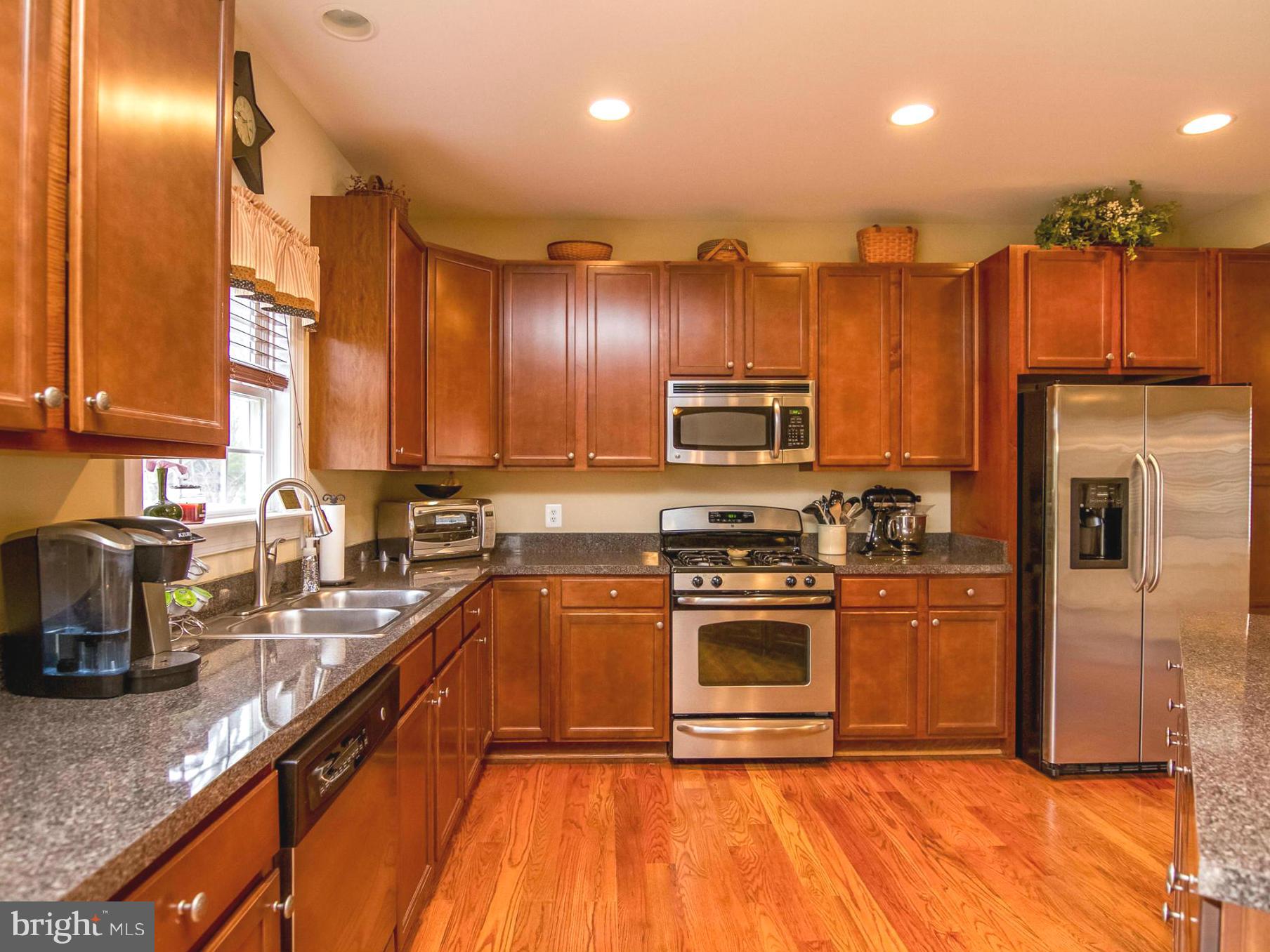 4021 Brummel Road Pasadena, MD 21122 - Photo 10 of 27 a kitchen with stainless steel appliances granite countertop a stove a sink and a refrigerator