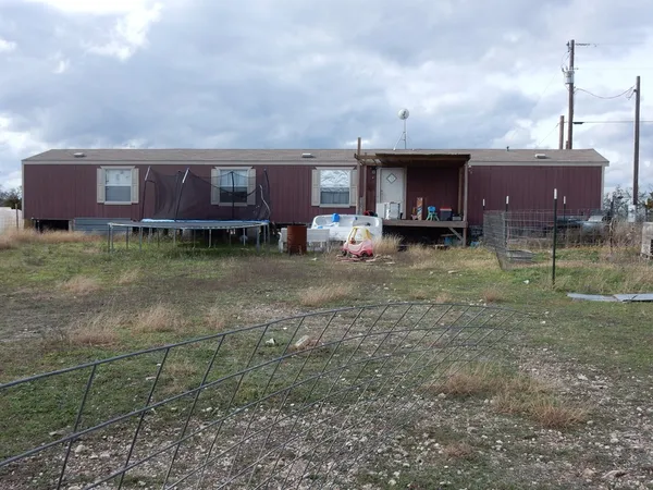 a view of a house with a backyard and porch