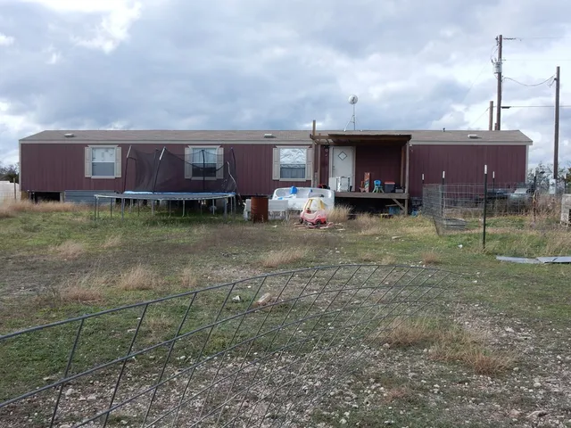 a view of a house with a backyard and porch