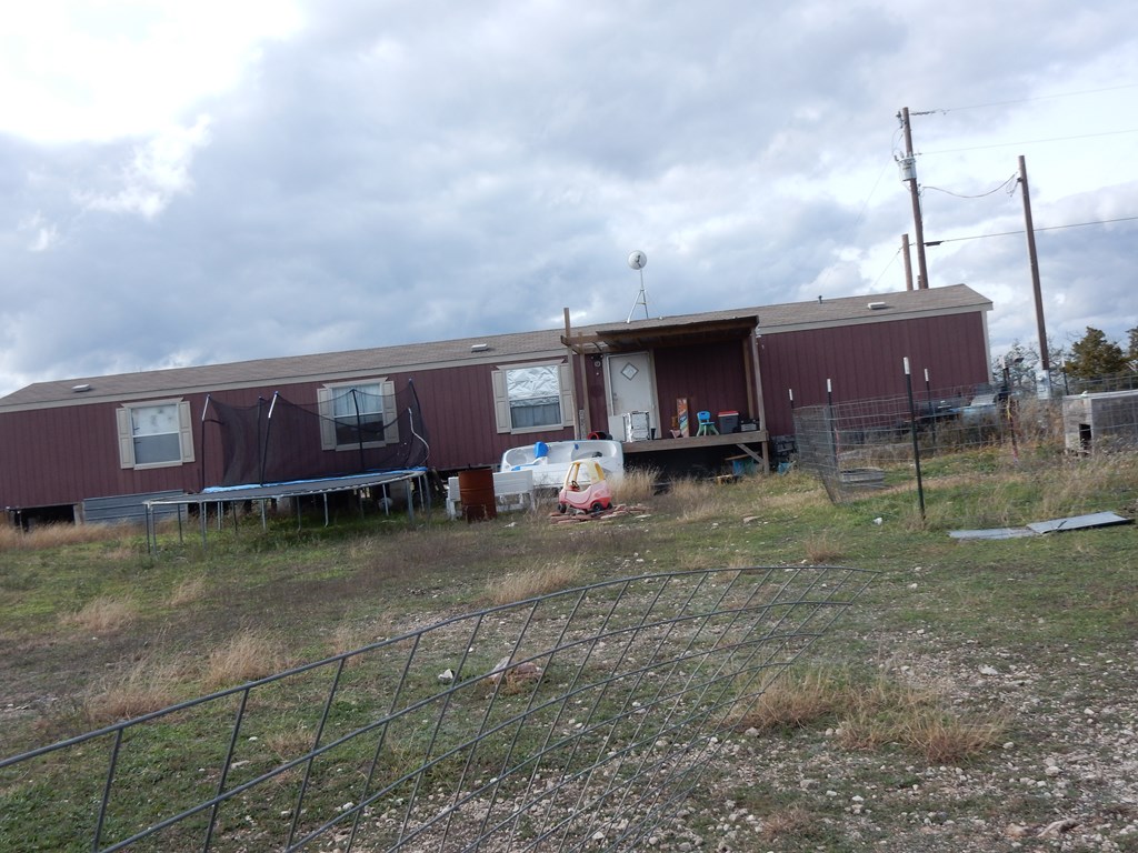 5101 Old Harper Road Harper, TX 78631 - Photo 7 of 17 a view of a house with a backyard and porch
