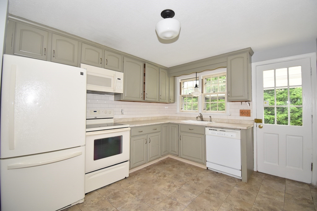 17 Old Brook Road Springfield, MA 01118 - Photo 11 of 23 a kitchen with white cabinets and white appliances