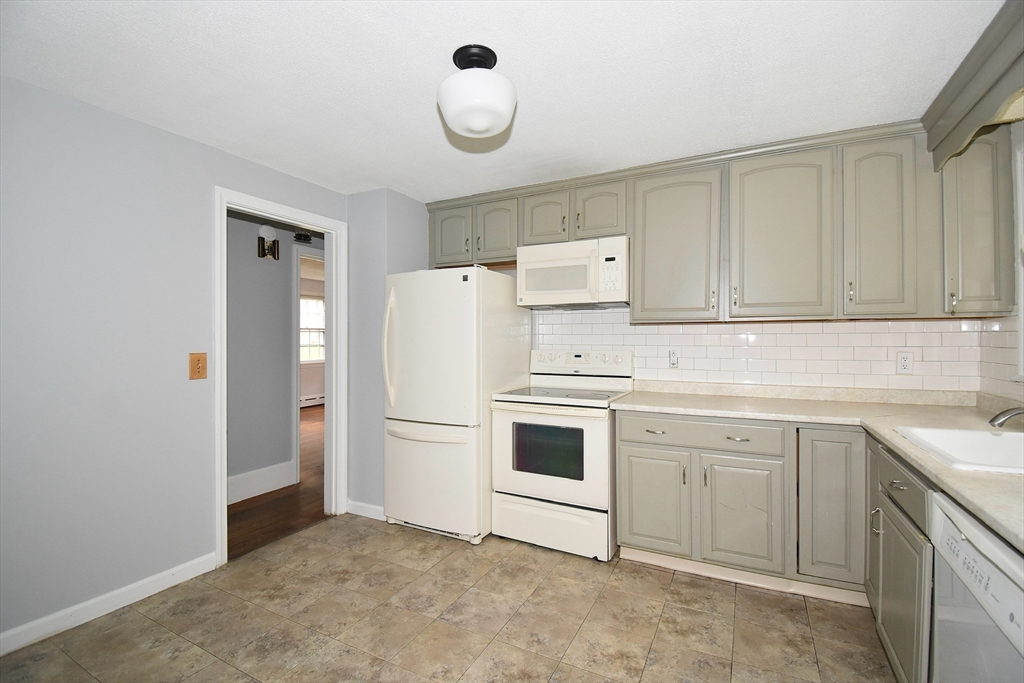 17 Old Brook Road Springfield, MA 01118 - Photo 12 of 23 a utility room with cabinets washer and dryer