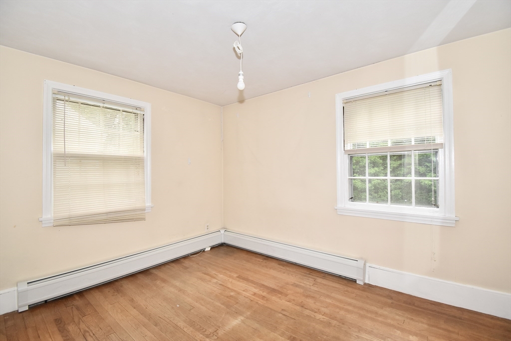 17 Old Brook Road Springfield, MA 01118 - Photo 14 of 23 an empty room with wooden floor and windows