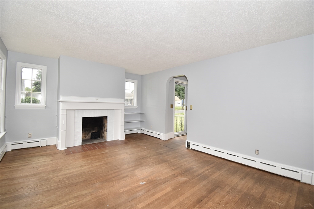 17 Old Brook Road Springfield, MA 01118 - Photo 8 of 23 an empty room with floor to ceiling window and fireplace