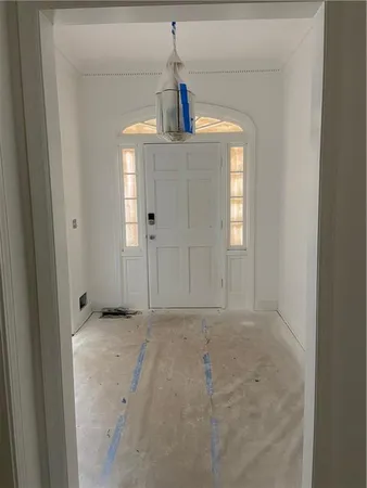 a view of a hallway with a chandelier fan