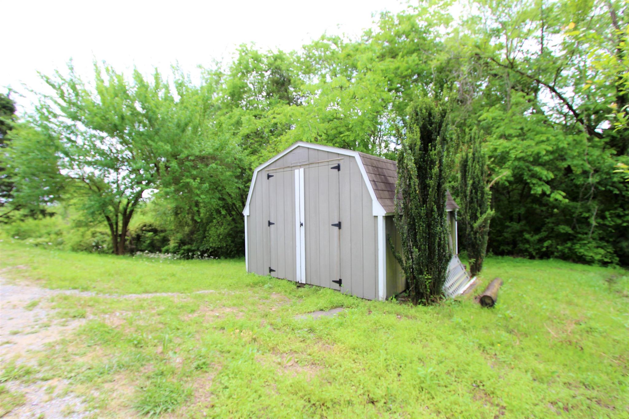 1073 Speck Road Lebanon, TN 37087 - Photo 15 of 20 a view of backyard with a barn and large trees