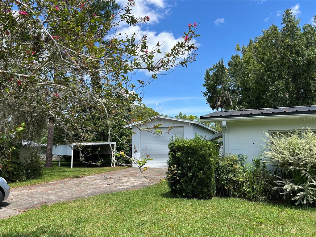 24121 Armadillo Road Astor, FL 32102 - Photo 3 of 11 a front view of a house with garden
