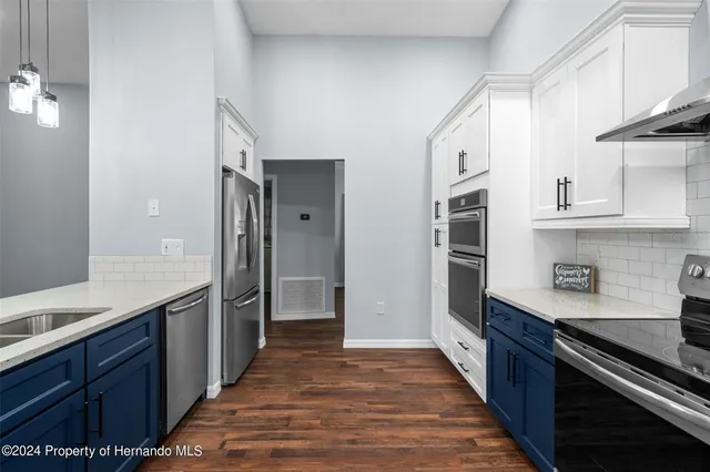 a kitchen with stainless steel appliances granite countertop a stove and a refrigerator
