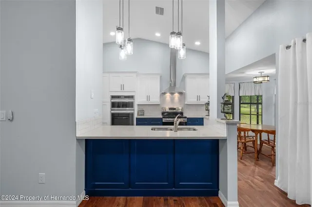 a living room with furniture a ceiling fan a lamp and a window