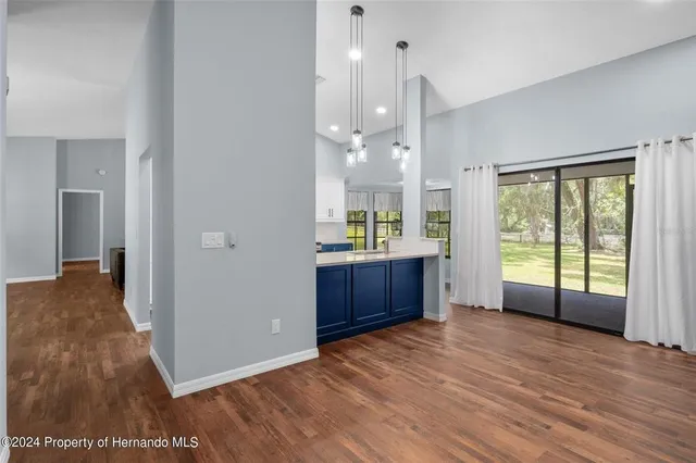 a living room with furniture and kitchen view