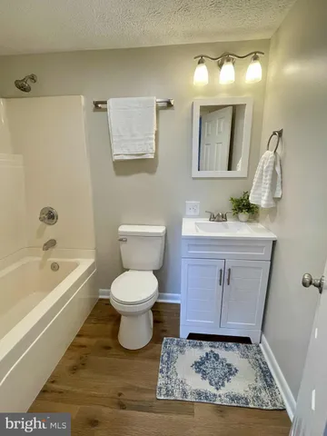 wooden floor in an empty room with a fireplace