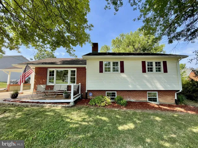 a front view of house with yard and outdoor seating