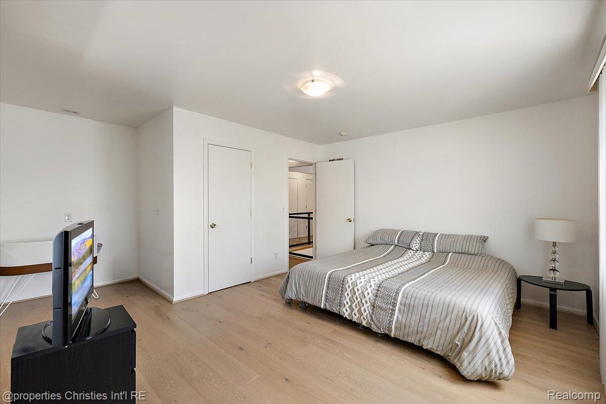 1830 Lone Pine Road Bloomfield Hills, MI 48302 - Photo 28 of 49 Bedroom with light wood-style flooring and baseboards