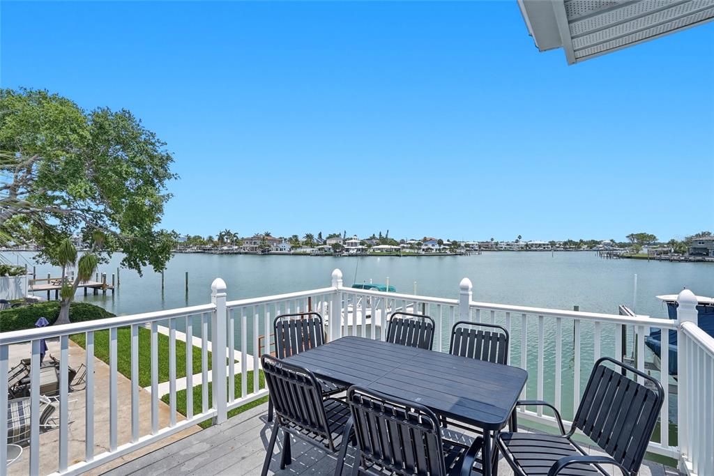 2311 Bay Boulevard Indian Rocks Beach, FL 33785 - Photo 43 of 80 a view of a deck with two chair and a floor to ceiling window
