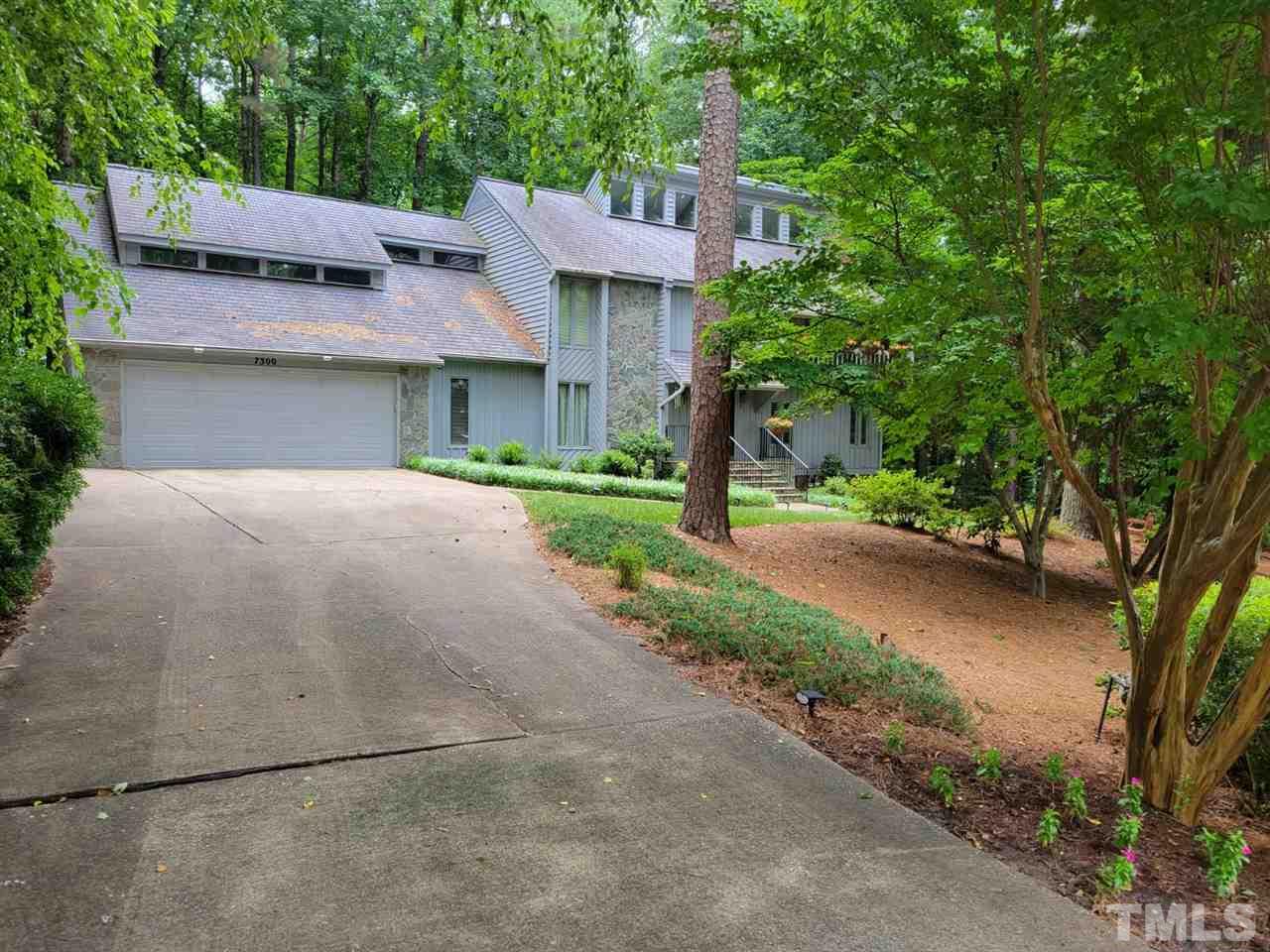 7300 Rainwater Road Raleigh, NC 27615 - Photo 2 of 18 a front view of a house with a yard and a garage