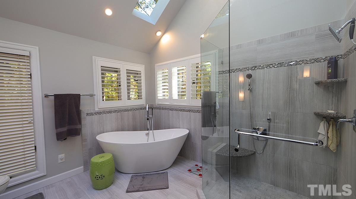 7300 Rainwater Road Raleigh, NC 27615 - Photo 11 of 18 a bathroom with a bathtub and shower