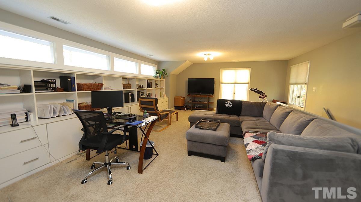 7300 Rainwater Road Raleigh, NC 27615 - Photo 13 of 18 a living room with furniture and a flat screen tv