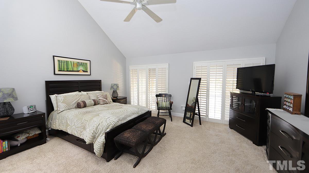 7300 Rainwater Road Raleigh, NC 27615 - Photo 8 of 18 a bedroom with a bed and a flat screen tv