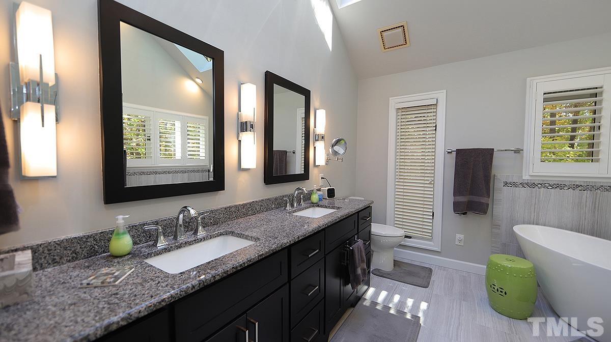 7300 Rainwater Road Raleigh, NC 27615 - Photo 10 of 18 a bathroom with a granite countertop sink and a mirror