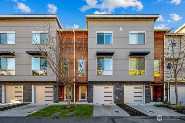 a front view of a residential apartment building with a yard