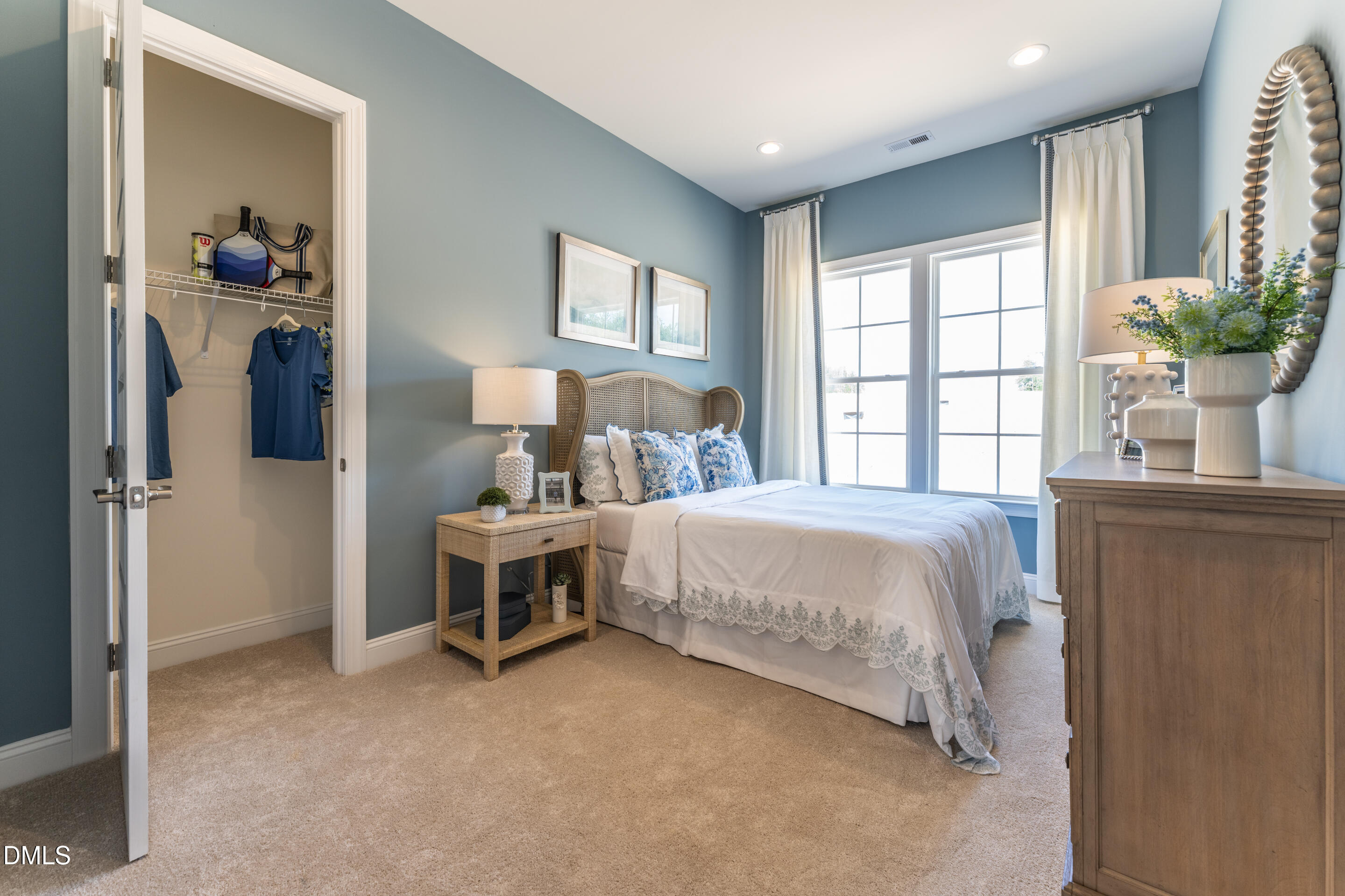 331 Oak Meadow Lane Angier, NC 27501 - Photo 23 of 32 a bed sitting in a spacious bedroom next to a window and a flat screen tv