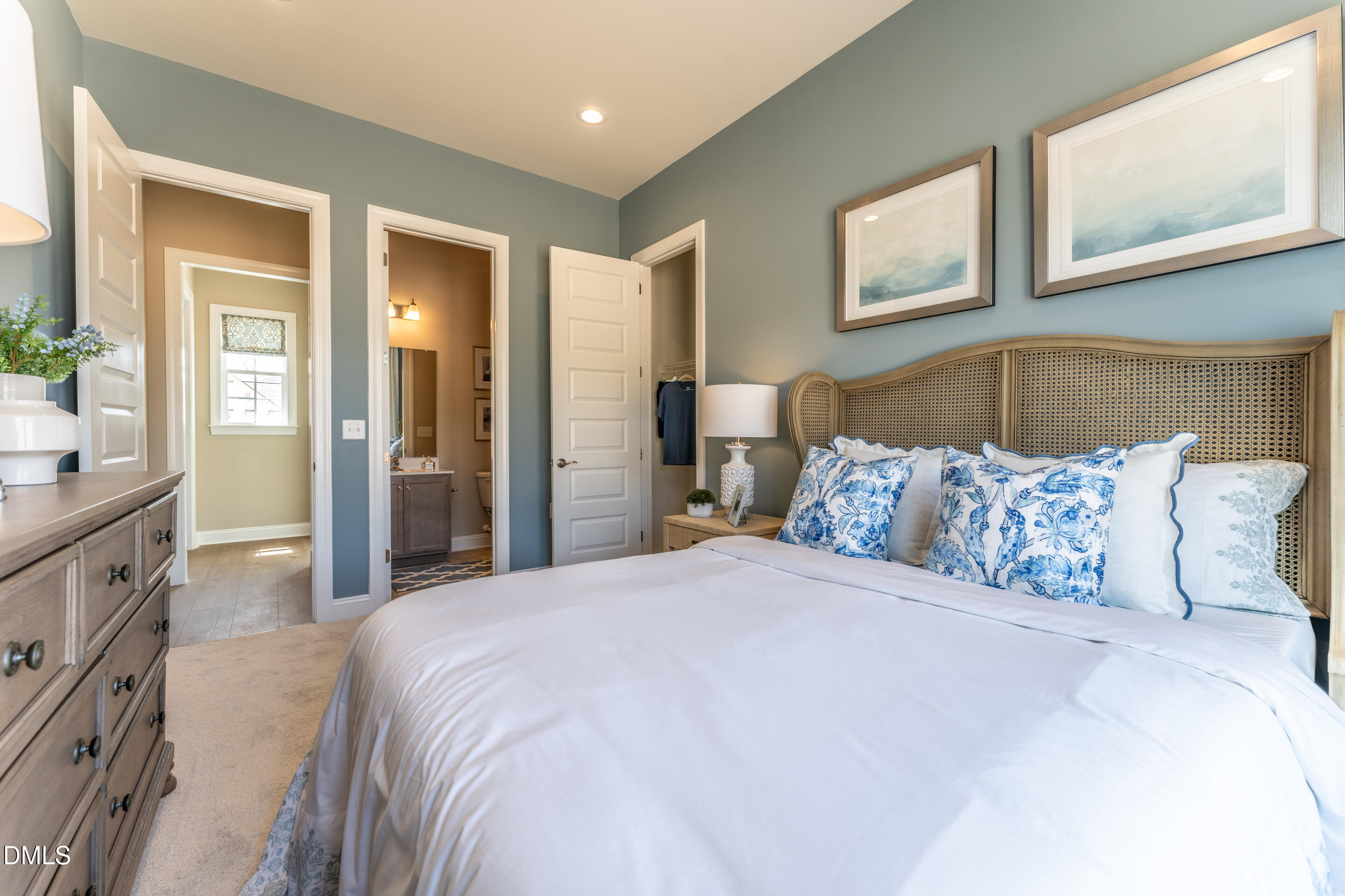 331 Oak Meadow Lane Angier, NC 27501 - Photo 24 of 32 a bedroom with a large bed and a chandelier